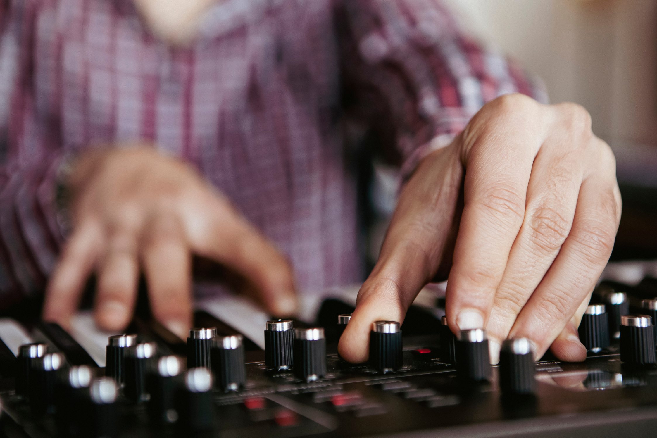 Man Playing Keyboards in Recording Studio